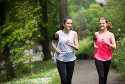 Two athletic woman running outdoors. Action and healthy lifestyle concept.